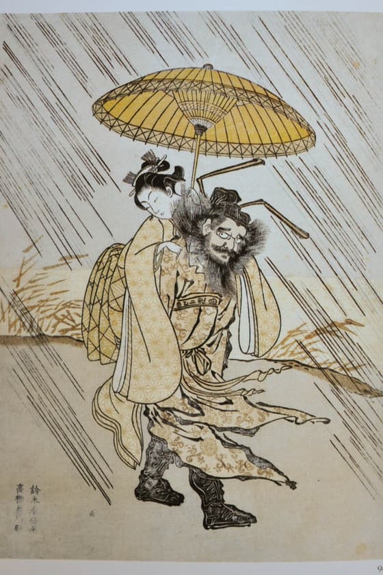 egoyomi (calendar print) showing Shôki, the demon killer, carrying a bijin. The "long months" show on the obi of the girl